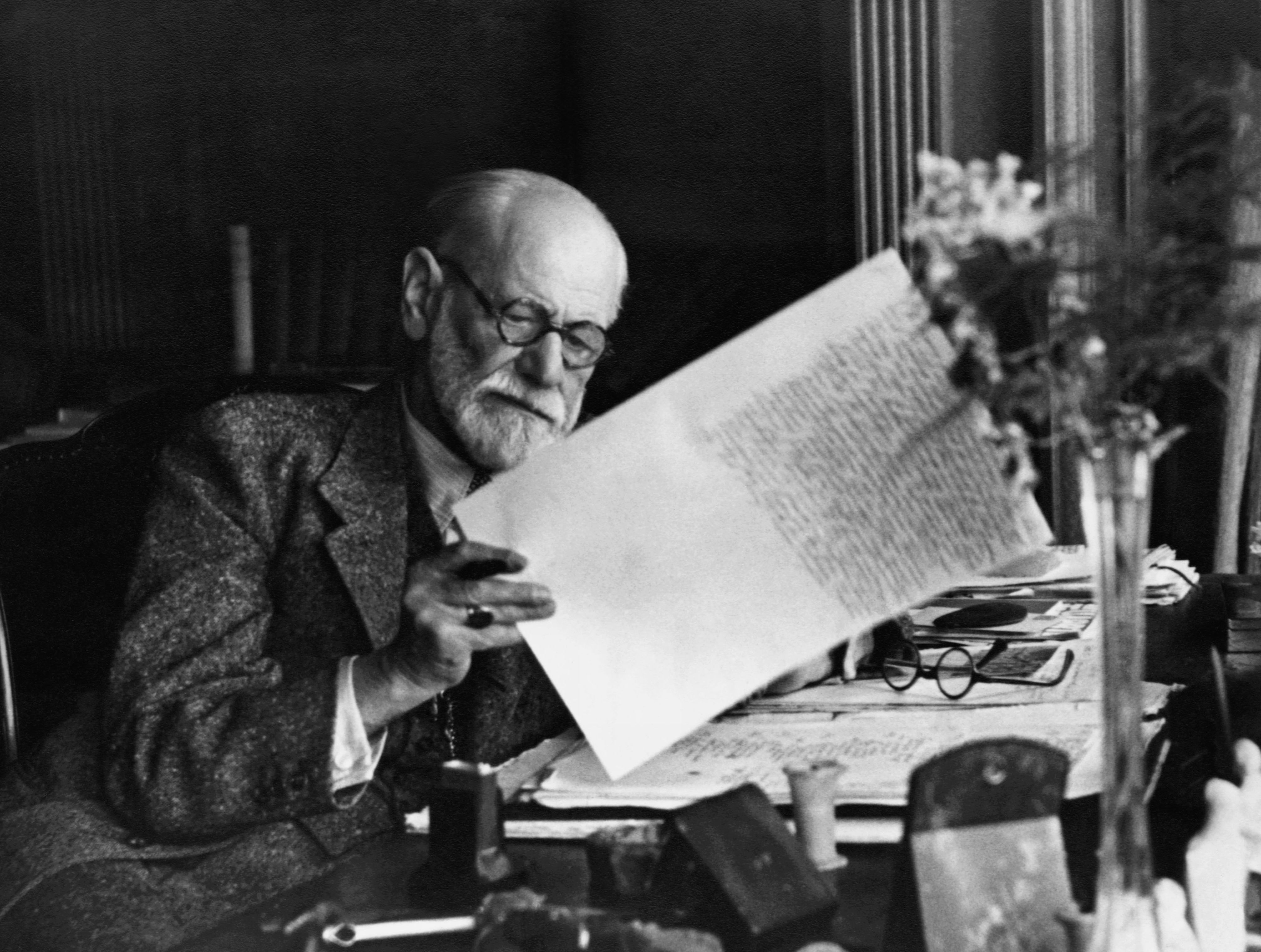 Original Caption: Sigmund Freud, 1856-1939, Austrian psychiatrist, in the office of his Vienna home looking at a manuscript. B/w photo ca.1930.